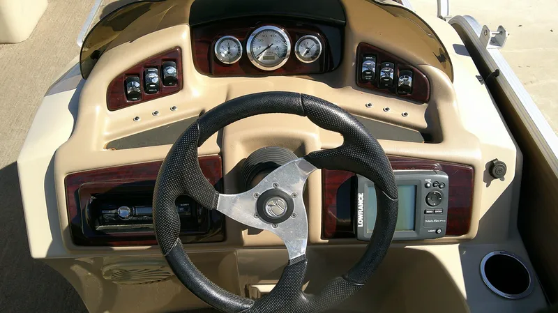 Slide: The Image of Dashboard of 2011 Bennington 2571 GLi boat with steering wheel and gauges. - 7