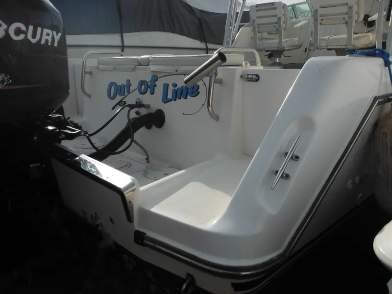Slide: The Image of 1999 Robalo 2440 Walkaround boat with "Out of Line" text on the stern. - 13