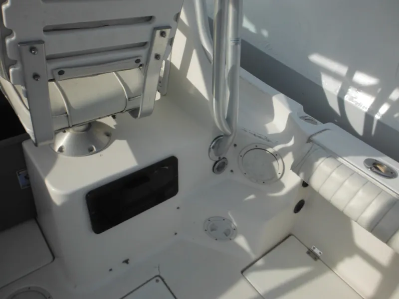 Slide: The Image of 1999 Robalo 2440 Walkaround boat interior with seating and storage compartments. - 18