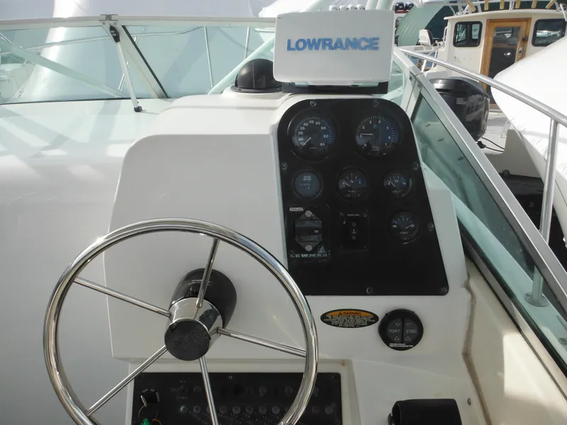 Slide: The Image of 1999 Robalo 2440 Walkaround boat dashboard with steering wheel and Lowrance navigation system. - 20