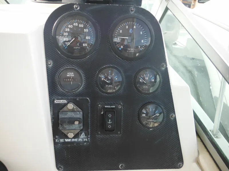 Slide: The Image of Dashboard of a 1999 Robalo 2440 Walkaround boat with gauges and controls. - 21