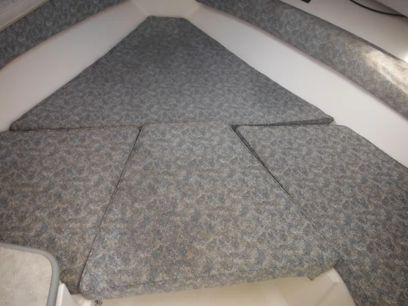 Slide: The Image of 1999 Robalo 2440 Walkaround cabin interior with cushioned seating. - 27