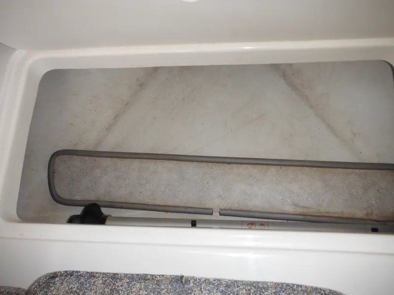 Slide: The Image of 1999 Robalo 2440 Walkaround storage compartment, empty and clean interior. - 32