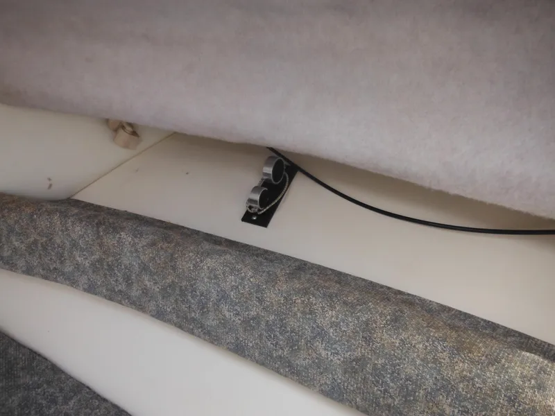 Slide: The Image of Interior view of a 1999 Robalo 2440 Walkaround boat, showing seating and storage area. - 33