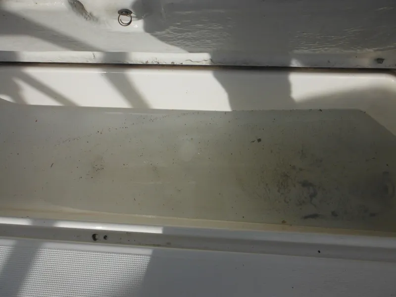 Slide: The Image of 1999 Robalo 2440 Walkaround boat interior detail with shadowed compartment. - 35