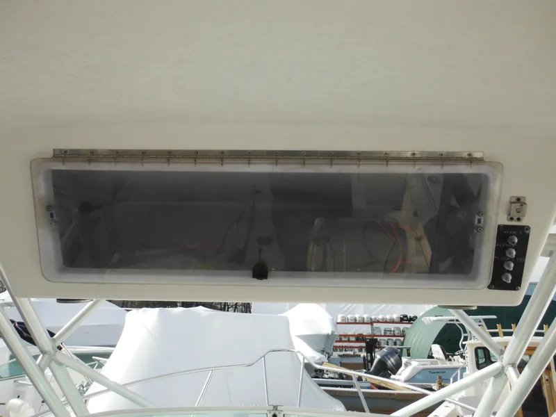 Slide: The Image of 1999 Robalo 2440 Walkaround boat console with storage compartment and control panel. - 39