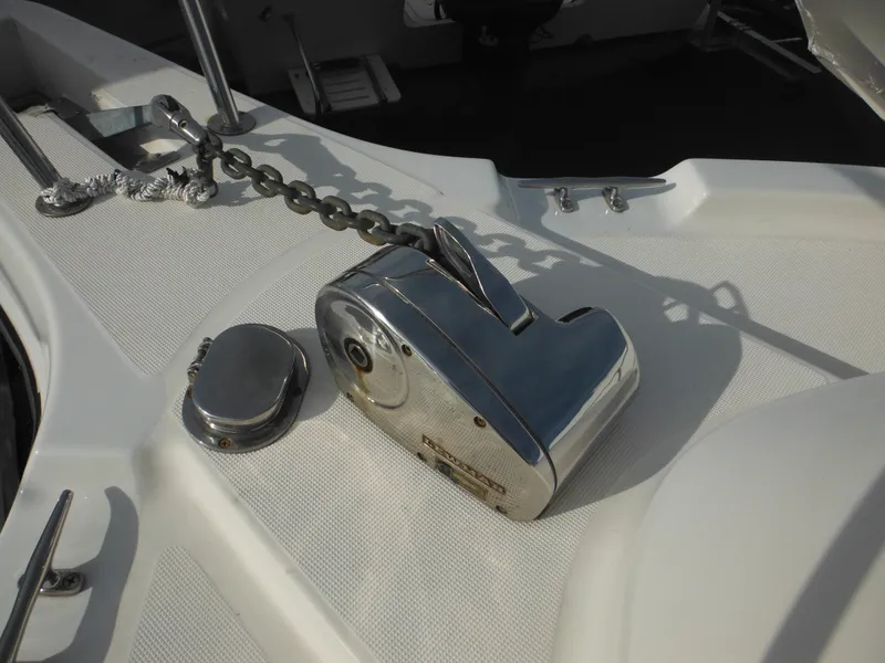 Slide: The Image of 1999 Robalo 2440 Walkaround boat anchor windlass on deck. - 42