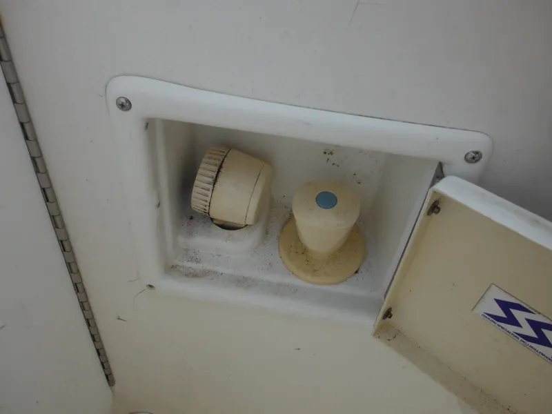 Slide: The Image of 1999 Robalo 2440 Walkaround boat control panel with knobs and cover. - 46