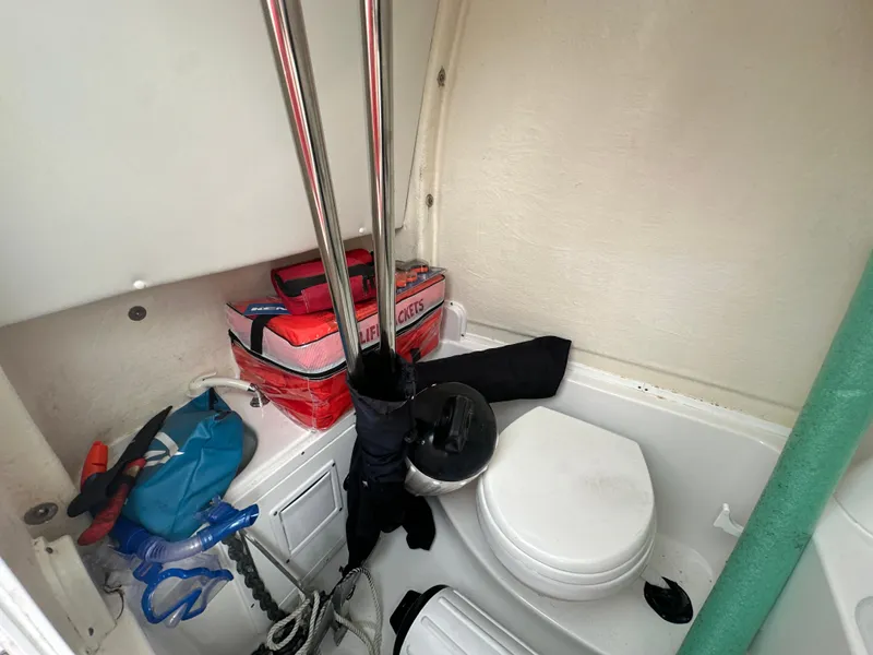 Slide: The Image of Interior of 2022 Tidewater 280 CC Adventure boat with storage and toilet area. - 22