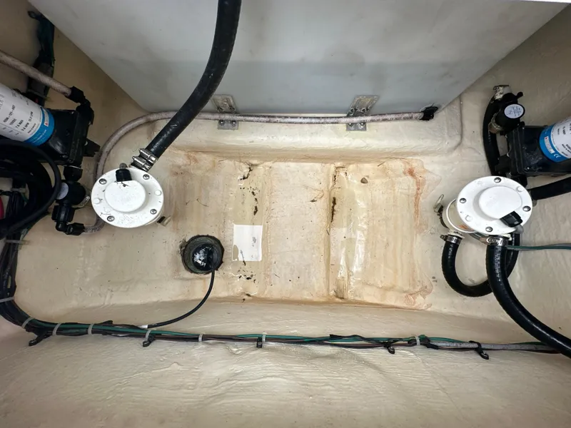 Slide: The Image of Bilge area of 2022 Tidewater 280 CC Adventure boat, showing pumps and hoses. - 25