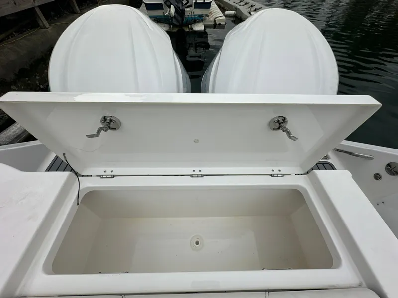 Slide: The Image of Open storage compartment on 2022 Tidewater 280 CC Adventure boat, docked by the water. - 7