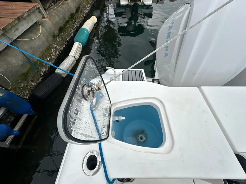 Slide: The Image of 2022 Tidewater 280 CC Adventure boat with open hatch and water view. - 8