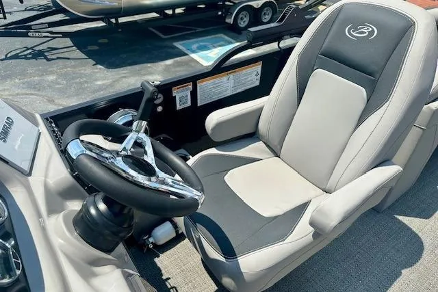 Slide: The Image of Captain's seat and steering wheel of 2025 Barletta A22QC boat, showcasing luxury design. - 7