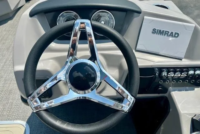 Slide: The Image of Steering wheel and dashboard of 2025 Barletta A22QC boat with Simrad display. - 8