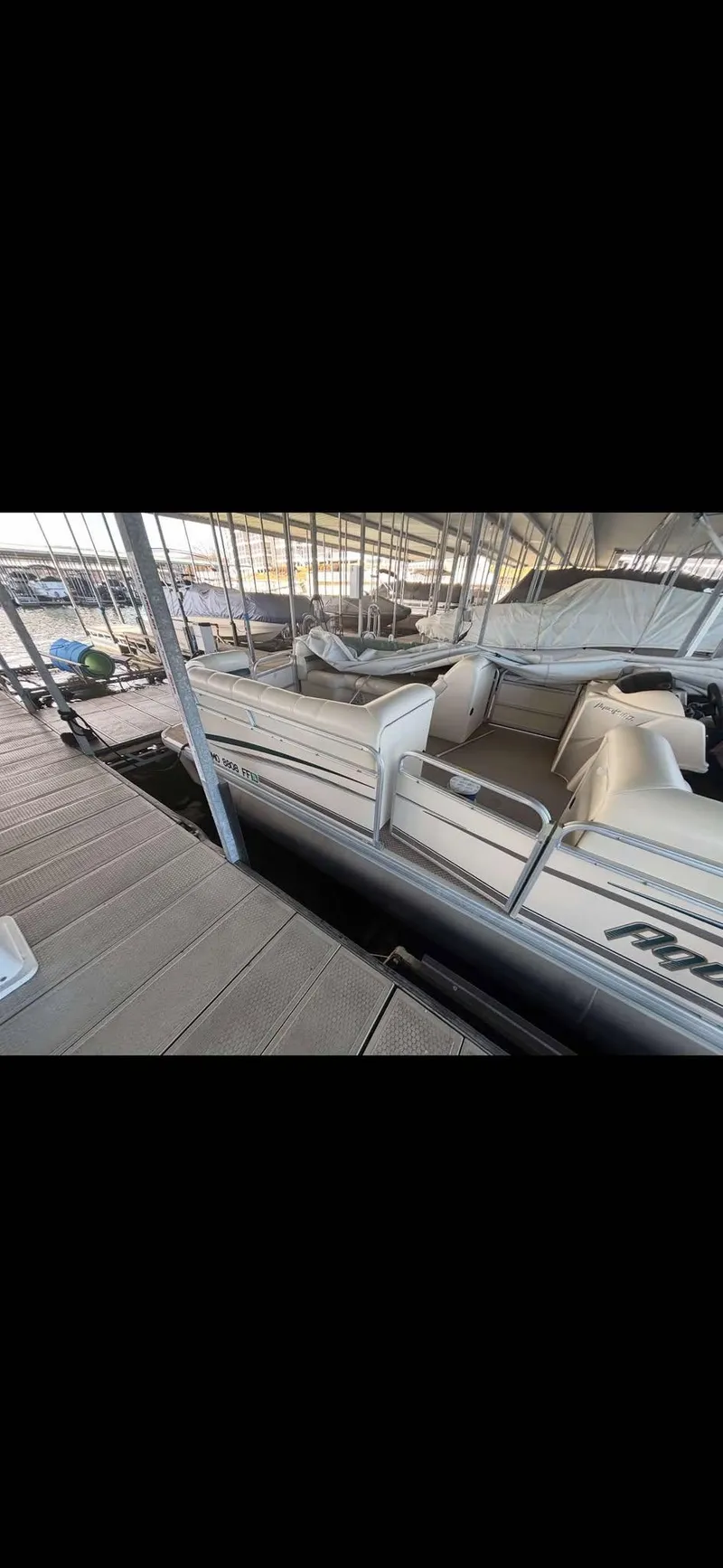 Slide: The Image of 2005 Godfrey AquaPatio 240 LE pontoon boat docked in a marina. - 11