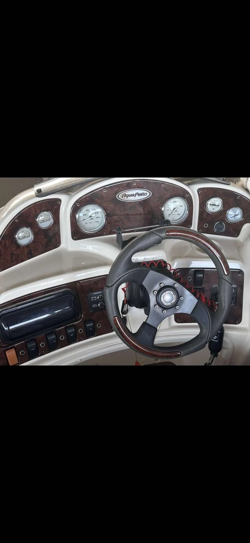 Slide: The Image of Dashboard of 2005 Godfrey AquaPatio 240 LE boat with steering wheel and gauges. - 12