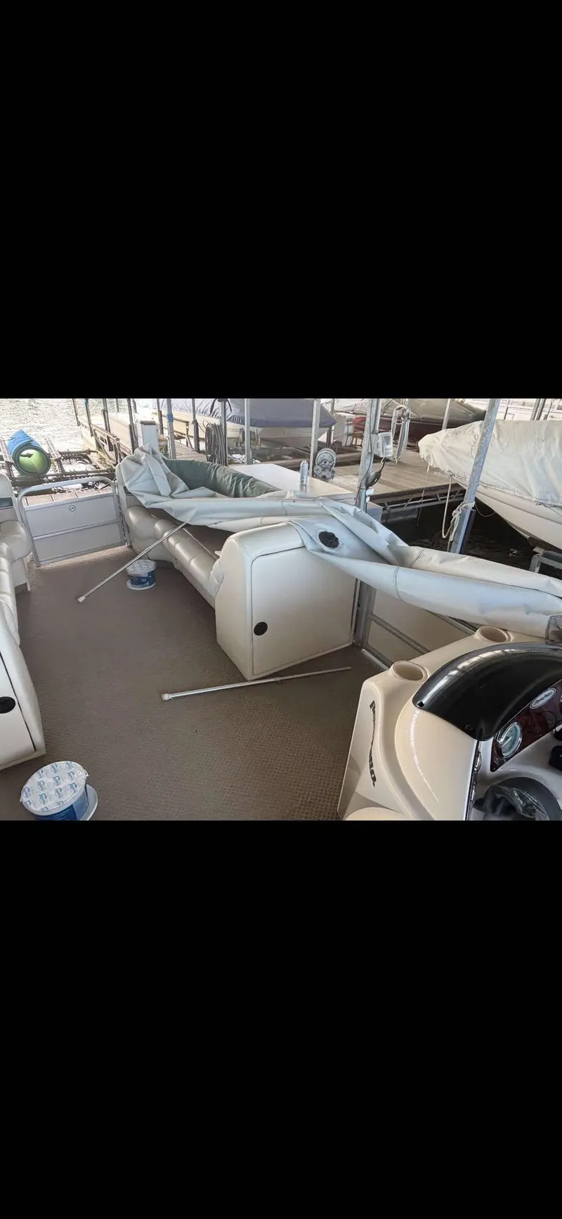 Slide: The Image of 2005 Godfrey AquaPatio 240 LE pontoon boat interior with seating and deck view. - 16