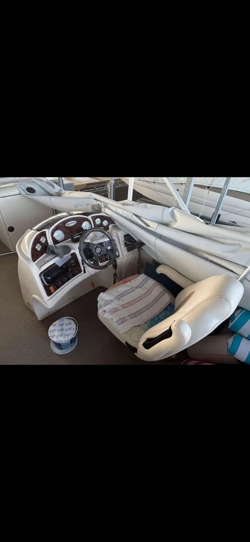 Slide: The Image of 2005 Godfrey AquaPatio 240 LE boat interior with steering console and seating. - 19