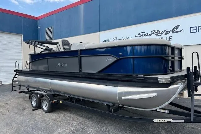 The Image of 2025 Barletta C22QC pontoon boat on trailer, parked outside dealership. - 0