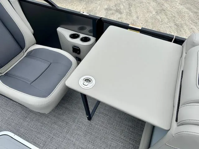 Slide: The Image of 2025 Barletta C22QC boat interior with seating, table, and cup holders. - 10