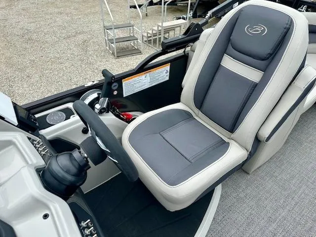 Slide: The Image of 2025 Barletta C22QC boat captain's seat with steering wheel and control panel. - 5
