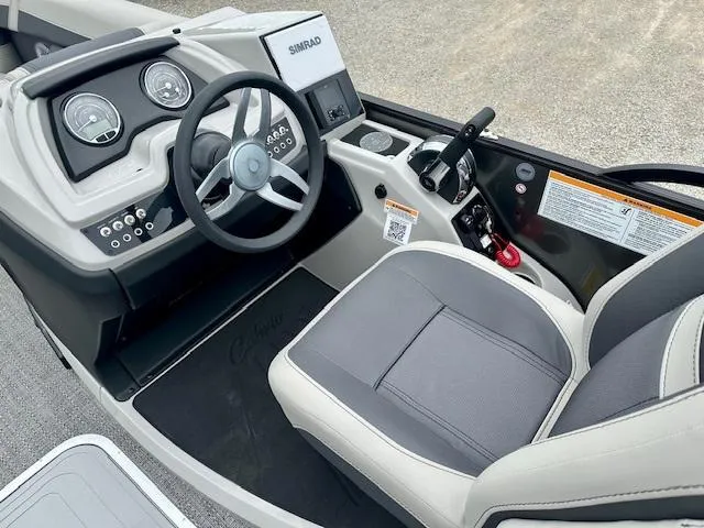 Slide: The Image of 2025 Barletta C22QC boat cockpit with steering wheel and control panel. - 8