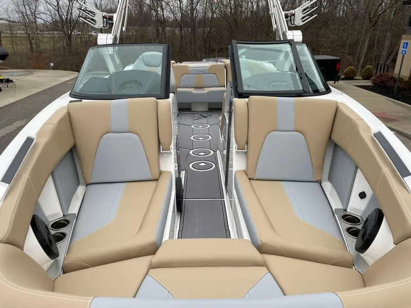 Slide: The Image of 2023 MasterCraft X24 boat interior with beige and gray seating, sleek design. - 10