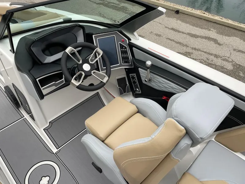 Slide: The Image of 2023 MasterCraft X24 boat interior with modern steering and seating. - 7