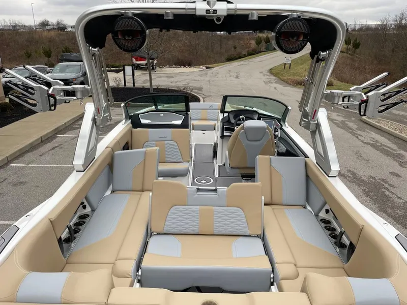 Slide: The Image of 2023 MasterCraft X24 boat interior with beige and gray seating, modern design, and spacious layout. - 8