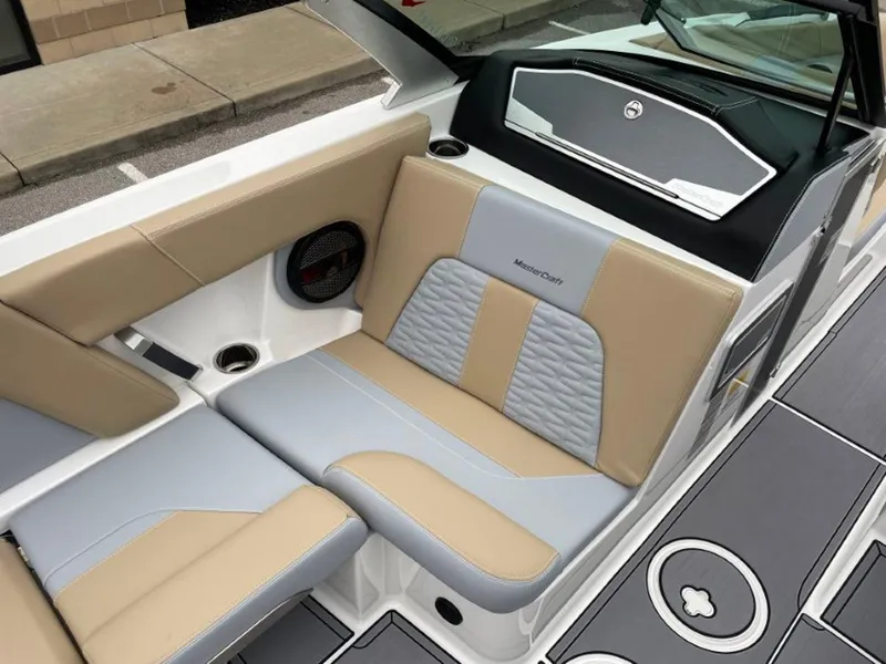Slide: The Image of 2023 MasterCraft X24 boat interior with beige and gray seating. - 9