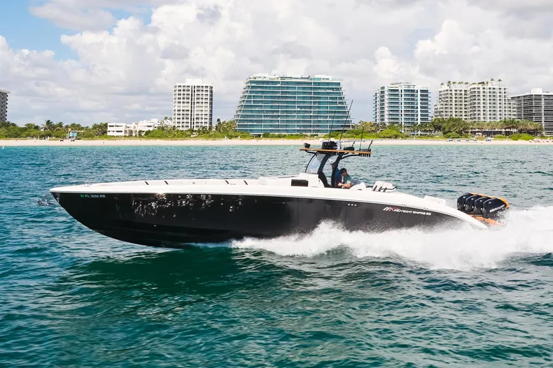 Slide: The Image of 2016 Midnight Express 43' Open boat cruising on ocean near city skyline. - 1