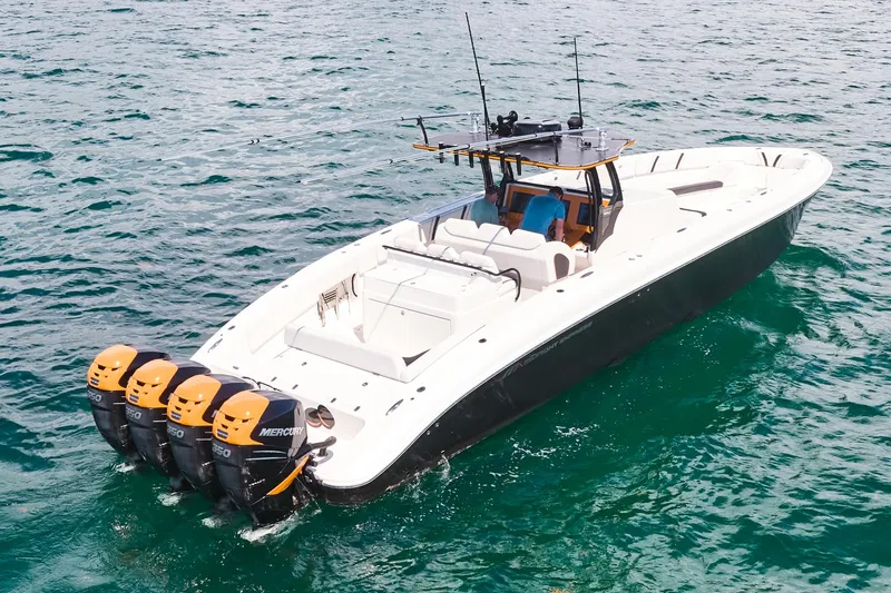 Slide: The Image of 2016 Midnight Express 43' Open boat with four Mercury outboard engines on the water. - 11