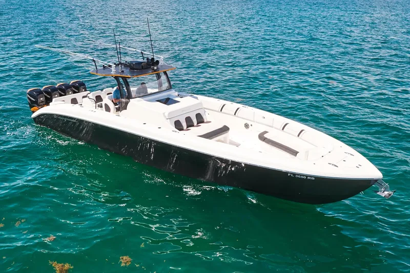 Slide: The Image of 2016 Midnight Express 43' Open boat cruising on clear blue water. - 12