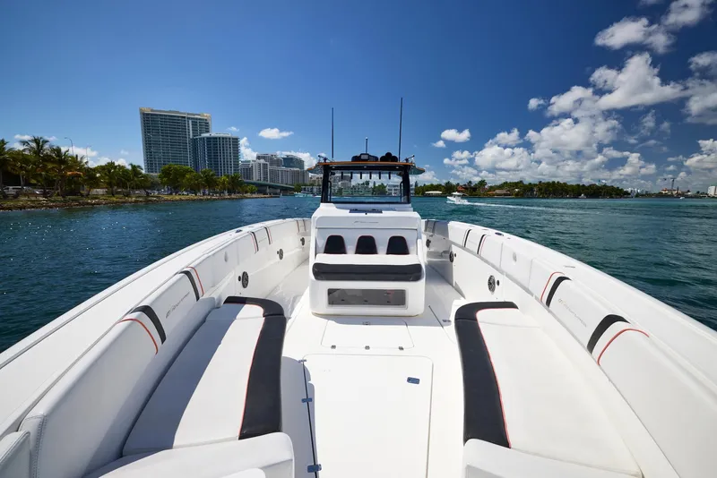 Slide: The Image of 2016 Midnight Express 43' Open boat cruising on a sunny day with city skyline in background. - 15