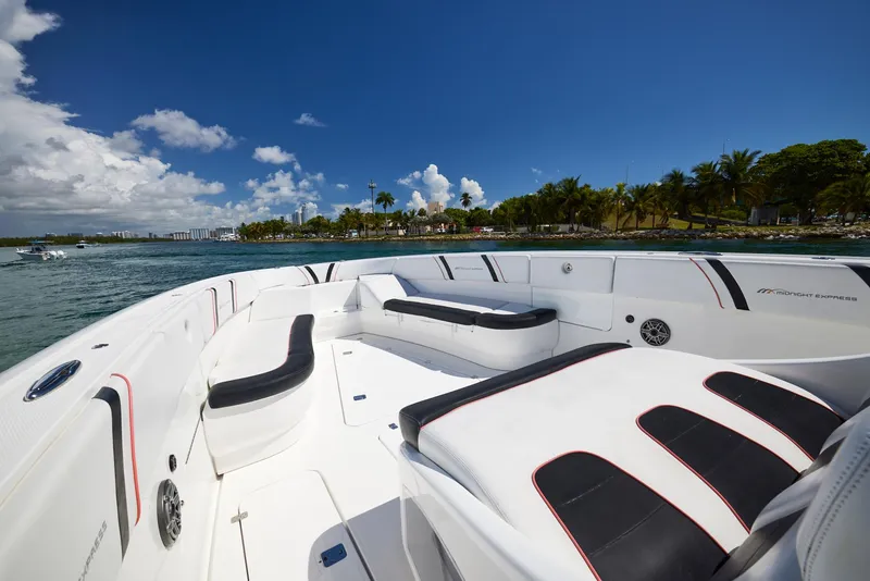 Slide: The Image of 2016 Midnight Express 43' Open boat with spacious seating, cruising on a sunny day. - 16