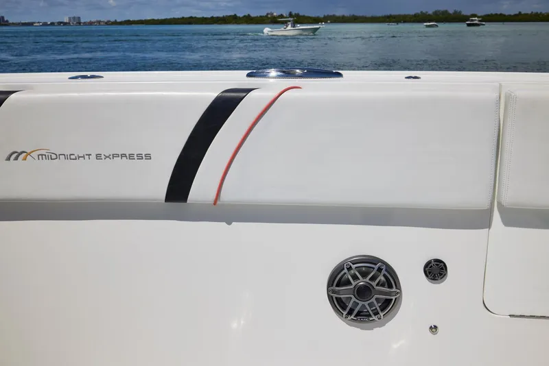 Slide: The Image of 2016 Midnight Express 43' Open boat detail with speaker, on calm water. - 19