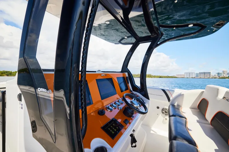 Slide: The Image of 2016 Midnight Express 43' Open boat interior with modern dashboard and steering wheel. - 24