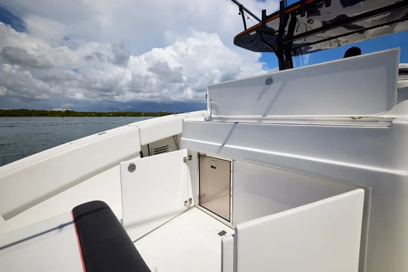 Slide: The Image of 2016 Midnight Express 43' Open boat, white deck, open storage, under cloudy sky. - 27
