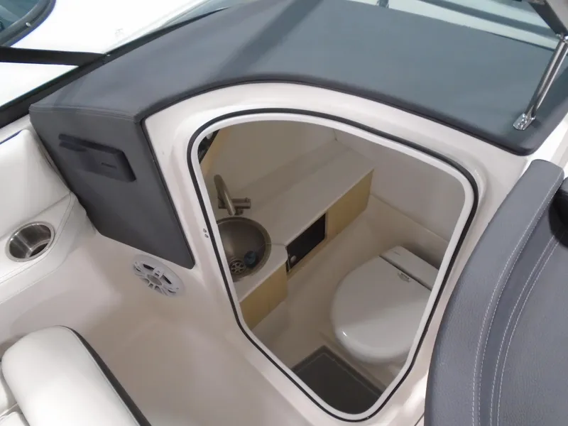 Slide: The Image of 2025 Regal LX4 boat interior with compact bathroom, featuring a toilet and sink. - 11