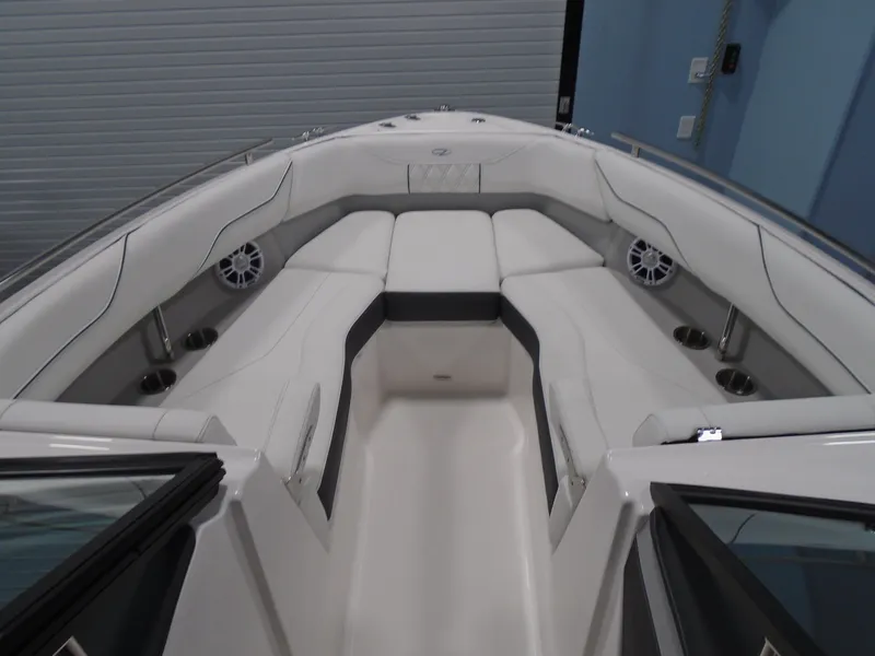 Slide: The Image of 2025 Regal LX4 boat interior with white seating and cup holders. - 13