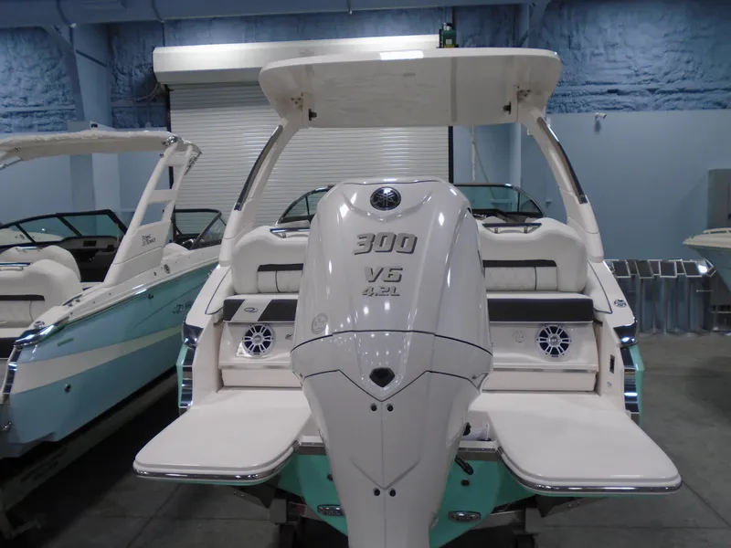 Slide: The Image of 2025 Regal LX4 boat with 300 V6 engine, displayed indoors. - 4