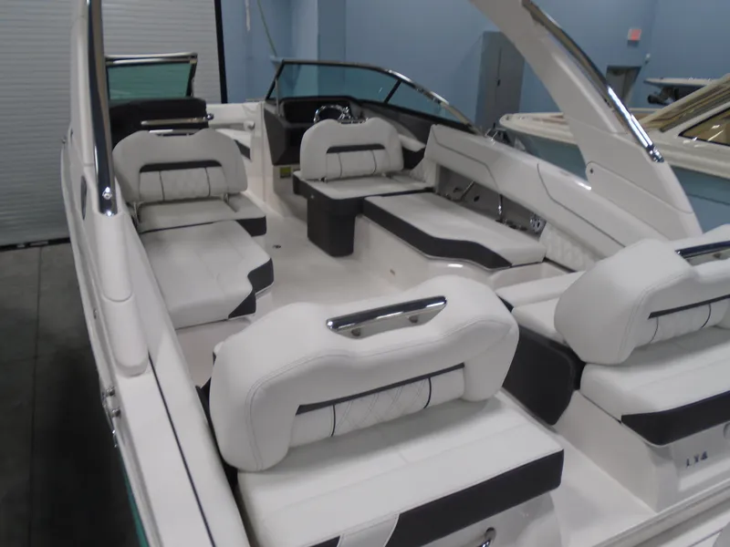 Slide: The Image of 2025 Regal LX4 boat interior with luxurious white seating and modern design. - 6