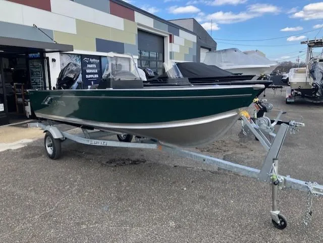 Slide: The Image of 2025 Lund 1600 Fury SS boat on trailer, parked outside a dealership. - 2