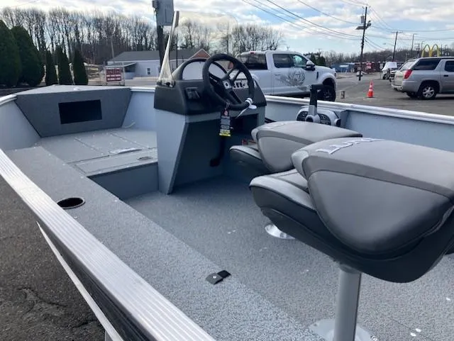 Slide: The Image of 2025 Lund 1600 Fury SS boat interior with steering console and seating. - 3