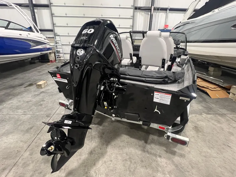 Slide: The Image of 2025 Princecraft Holiday 162 WS MAX boat with Mercury 60 engine in a garage. - 10
