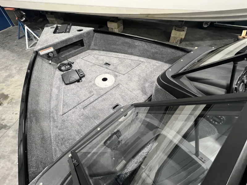 Slide: The Image of 2025 Princecraft Holiday 162 WS MAX boat interior with gray carpet and windshield. - 14