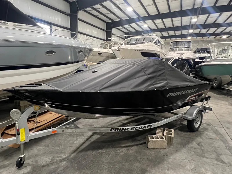 Slide: The Image of 2025 Princecraft Holiday 162 WS MAX boat covered in storage, displayed on a trailer. - 16