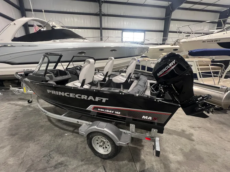 Slide: The Image of 2025 Princecraft Holiday 162 WS MAX boat in showroom, featuring sleek design and Mercury engine. - 9