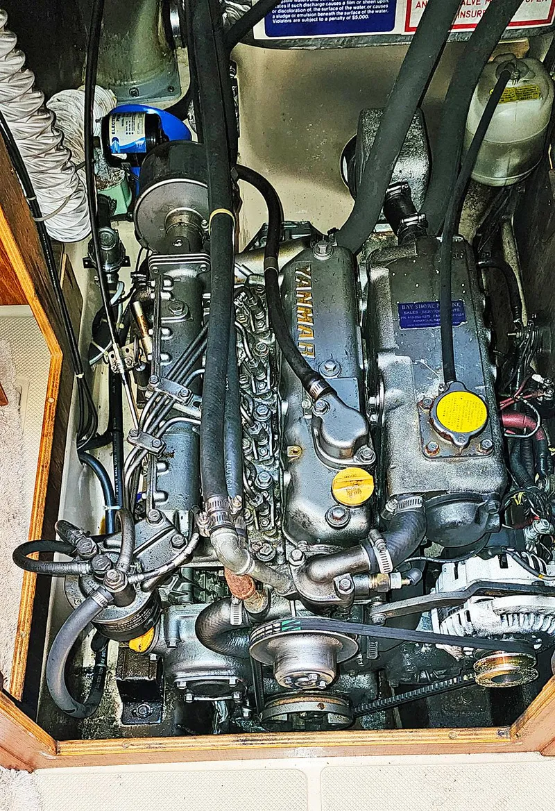 Slide: The Image of Engine compartment of a 1988 Island Packet 38 sailboat, featuring a Yanmar marine engine. - 11