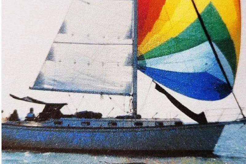Slide: The Image of 1988 Island Packet 38 sailboat with colorful spinnaker on the water. - 14